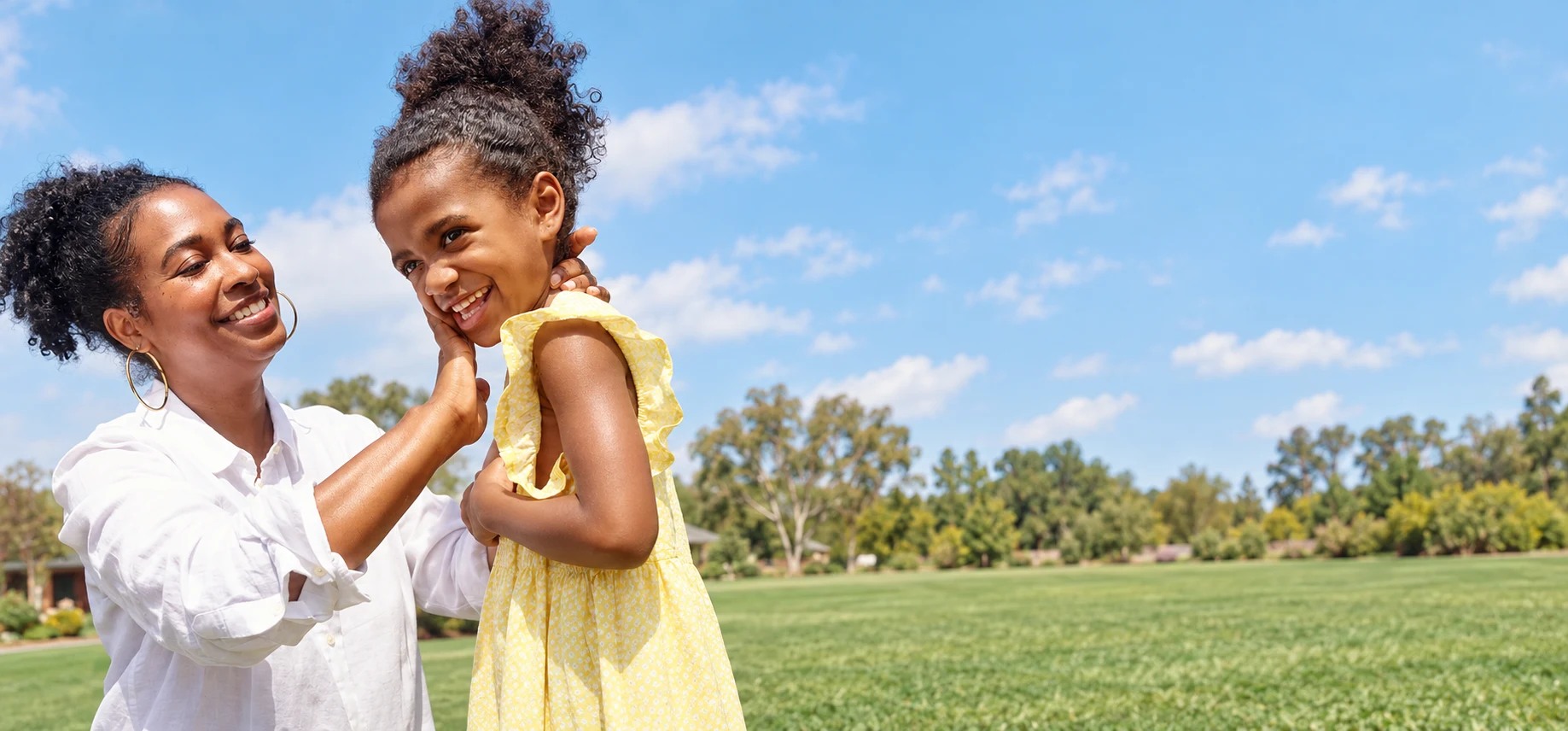 Mother applying sunscreen to her child outdoors